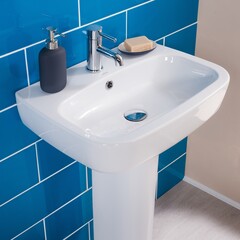 New and modern steel faucet with the ceramic sink in the bathroom