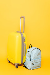 travel bag with backpack on yellow background