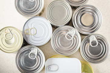 Flat lay view at various canned foods in tin cans on kitchen table, non-perishable, long shelf life...