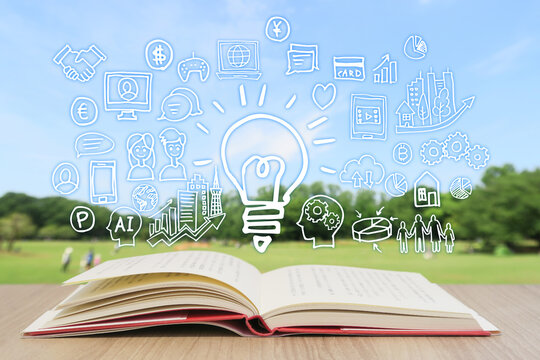 読書で学習する様々な知識・緑と青空背景-スマホ・パソコン・ネットワーク・ビジネスのアイデア