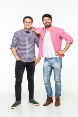 Two handsome men wearing casual t-shirt and jeans smiling and posing together on camera isolated over white background