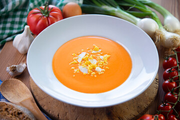 Traditional spanish Salmorejo. Cold tomato soup made with garlic, tomatoes, onion, bread and served with olive oil, iberico ham and boiled egg.