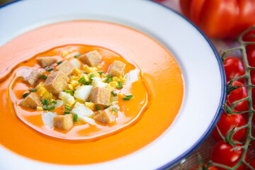 Veggie spanish Salmorejo. Cold tomato soup made with garlic, tomatoes, onion, bread and served with olive oil, deep fried tofu and boiled egg.