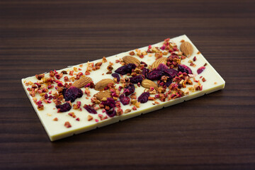 A bar of white chocolate with dried berries, candied fruits and almonds.