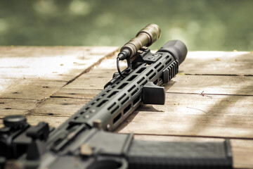 Military AR15 automatic assault rifle weapon with aim sight and flashlight
