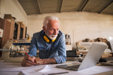 Senior architect looking at the laptop