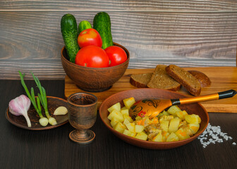 village lunch with potatoes, vegetables, vodka, garlic and onions