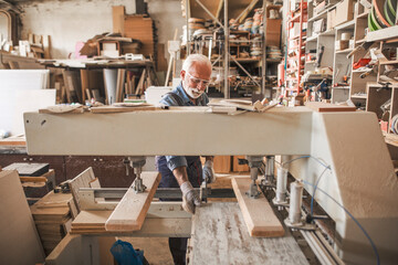 Joiner in a big carpentry workshop