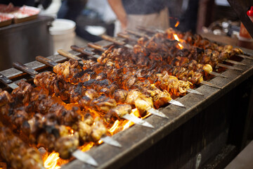 Meat skewers in preparation at winter night market