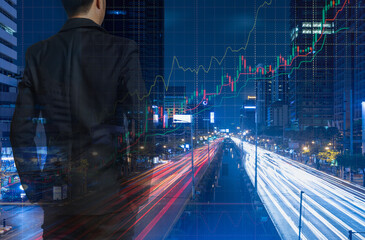 Businessman with stock graphs and city