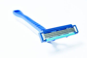 blue plastic shaver arranging on white background