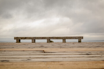 Obraz na płótnie Canvas wooden bench on the beach
