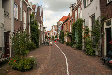 Fototapeta na wymiar Deventer, Netherlands - July 11 2020: Famous Walstraat in the Dutch historic city center of Deventer