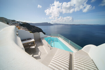 Beautiful pool villa landscape with sea view, white architecture on Santorini island, Greece.