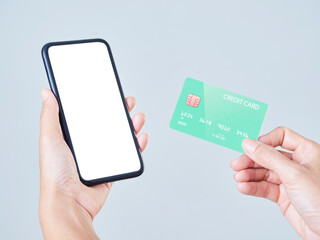 Woman with smartphone and credit card