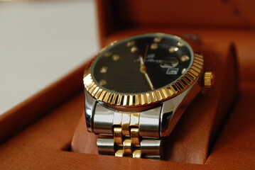 beautiful luxury wrist watch silver ,golden,black contrast with soft focus blurred background..