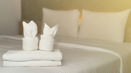 Fototapeta na wymiar White bath towel on bed decoration interior in hotel.
