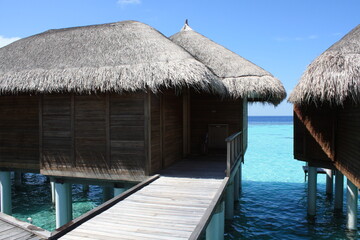 Beautiful paradise beach panorama with turquoise water sea and overwater bungalow and pier in the...