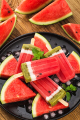 Homemade watermelon popsicles on a plate. Summer food concept.