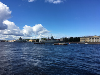 Warships in the water area of ​​the Neva, arrived to participate in the naval parade in St. Petersburg, and pleasure boats with tourists.