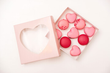 Sweet macarons in gift box. Traditional french colorful macarons. Valentine's day gift. Pink macarons in the heart shape.