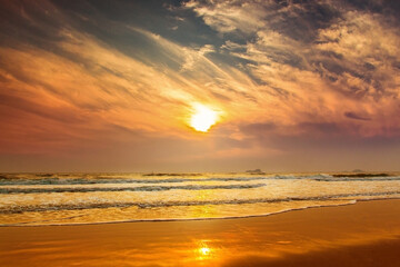 Naklejka na ściany i meble Sun is fall down sunset with sea and beach and waving clear sky