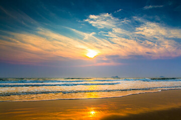 Sun is fall down sunset with sea and beach and waving clear sky