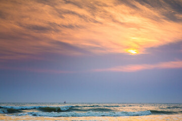 Obraz premium Sun is fall down sunset with sea and beach and waving clear sky