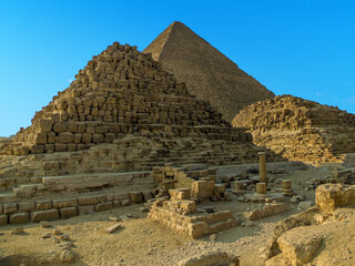 A view of the Great Pyramid at Giza, Egypt with small burial step pyramids in the foreground in the...