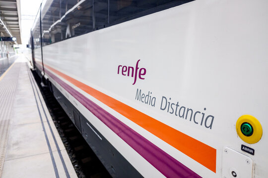 Valencia, Spain - July 8, 2020: Medium distance train of the Spanish company Renfe, logo on a train stopped on the platform.