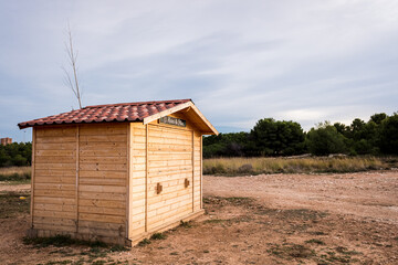 Wooden kiosk closed on a Sunday afternoon in a park.