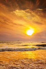 Fototapeta na wymiar Sun is fall down sunset with sea and beach and waving clear sky
