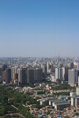 Obraz premium Top view of XI'an city.Panorama. Lots of high-rise buildings, demolition of old houses, a Park against the blue sky...