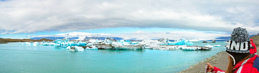 Icebergs in Jokulsarlon lagoon, Iceland, part of the Vatnajokull glacier national park. In the background the sunlit Hvannaldshnúkur, Iceland's highest peak.