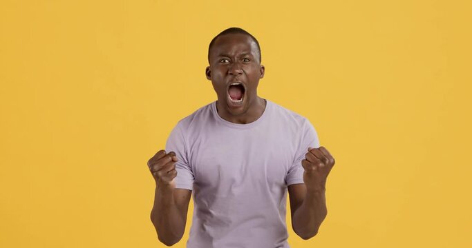 Emotional furious african american man shouting at camera