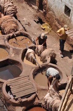 Man working at Chouwara Traditional leather tannery in Fez, Morocco
