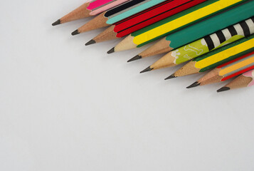 A pencil arranged in a row on a white background.