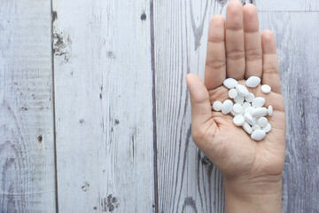 Close up of women hand taking pills with copy space 