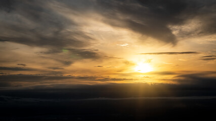 The sky with black clouds, orange at morning with beautiful sun and orange light.