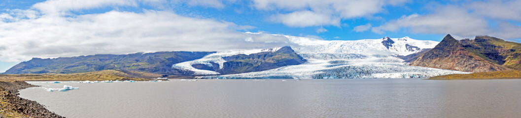 Fjallsjökull glacier and Fjallsarlon lagoon under the sunlit Hvannaldshnúkur, Iceland's highest peak, part of the Vatnajokull glacier national park