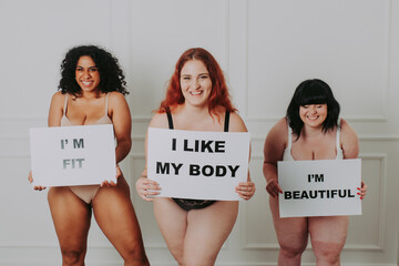 Body acceptance concept.  curvy girl posing in studio against society prejudice - obrazy, fototapety, plakaty