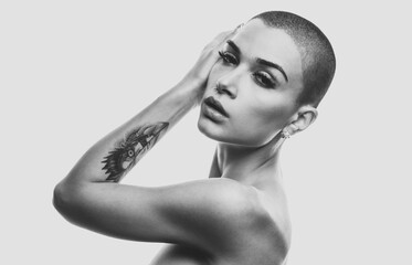 Modern beauty portrait. Young woman with shaved head