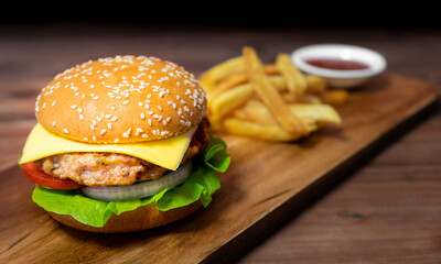 Hamburger and french fries on wooden table
