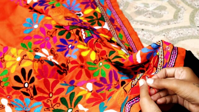 Hands of girl woman female in Indian traditional type pattern sewing embroidery pattern close up view,Hands of senior woman, needlework,woman doing embroidery

