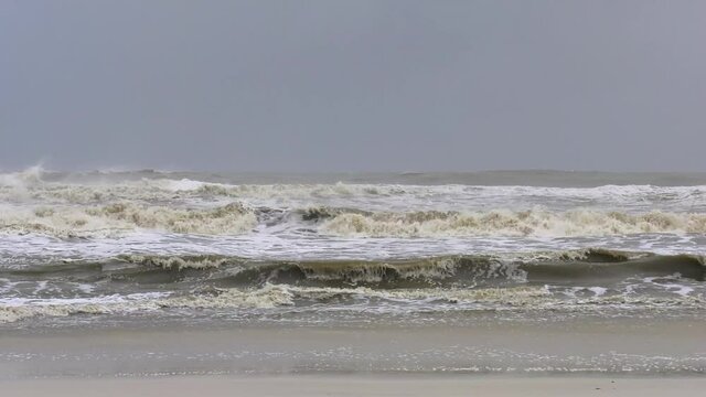 Strong fast ocean waves crashing towards a beach
