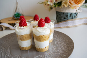Cheesecake cupcake with raspberry on top.