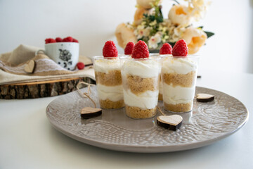 Cheesecake cupcake with raspberry on top.