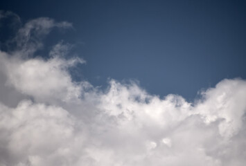 Cumulus clouds look like fluffy, white cotton balls in the sky.