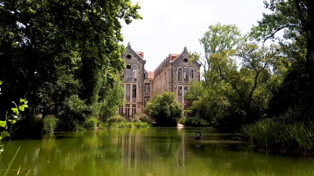 The old military headquarters and high school college building reflected over the lake at Parque D. Carlos I, in Caldas da Rainha, Silver Coast, Portugal