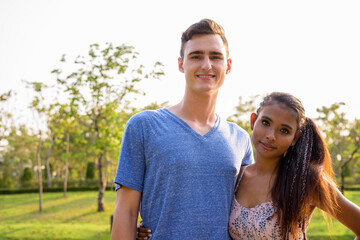 Portrait of young multi ethnic couple relaxing together at the park